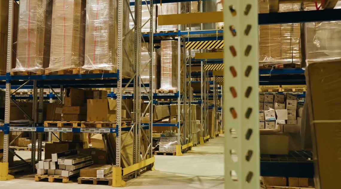 Tall warehouse racking at the logistics centre, filled with palletised goods